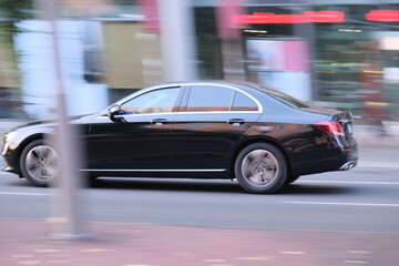 Fototapeta na wymiar Fast moving car on a street