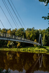 Scenic landscape of river in Gauja national park near Sigulda in Latvia. Modern architecture of bridge.
