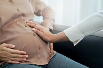 Doctor checking belly of a pregnant woman