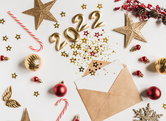 Envelope with e card and various stars with numbers of 2022 imitation of explosion and festive seasonal decorations