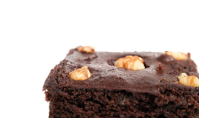 Vegan brownie closeup with chocolate icing and nuts. Partial perspective view of delicious fudgy dark and moist chocolate brownie. Selective focus. Isolated on white.