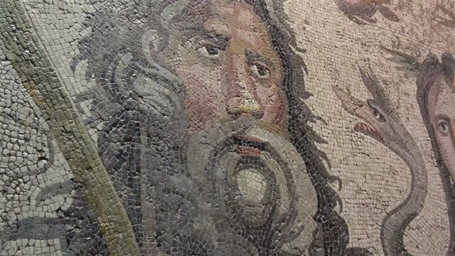 Gaziantep, Turkey - 13th of June 2021: 4K Zoom out close up faces on Oceanus and Thetys mosaics in the Zeugma museum

