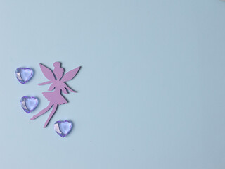 Top view flatlay lie concept view of little small Fairy, color background angel, background for children's party, fairy tale