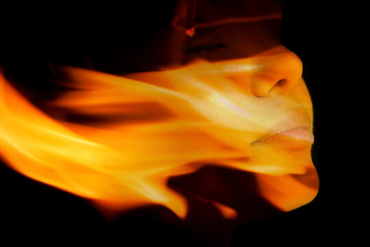 A portrait of a pretty woman combined with a close up photograph of a flame