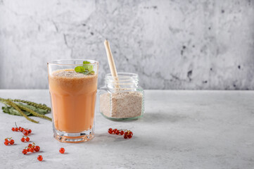 a glass of smoothie made of red currant berries and yogurt with psyllium husk-psyllium