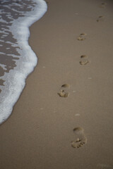 The waves wash away the footprints in the sand