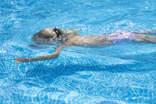 Little girl swimming in a pool