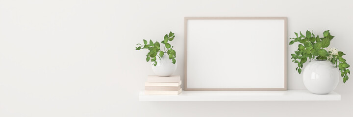 Empty picture frame mockup on a shelf with books and plants in porcelain vases. Web banner format...