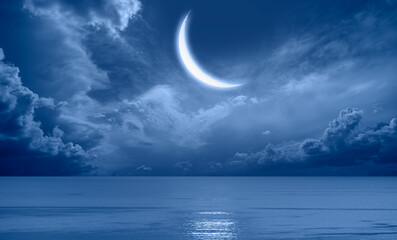 Crescent moon over the tropical sea at night 