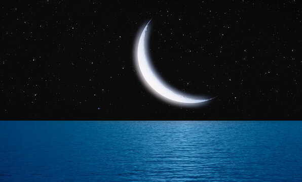 Crescent moon over the tropical sea at night "Elements of this image furnished by NASA"
