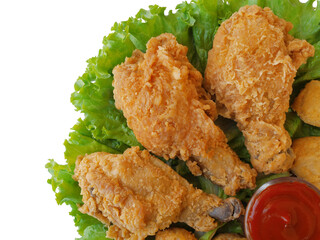 Fried yummy chickens and chicken nuggets with some ketchup and lettuce on a white background