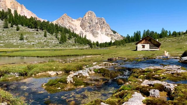 Mountain lake during summer in the dolimite alps with mountains and hut in the background, Fanes Sennes Prags National Park, South Tyrol, Italy