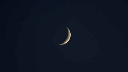 waning crescent Moon on dark sky
