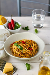 spaghetti pasta aglio e olio with chili flakes parsley garlic on white background