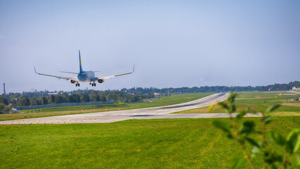 Fototapeta premium Airplane landing on the airport. Perfect view on the airplane with different high.