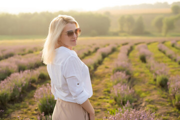 Fototapeta na wymiar A Woman Walking in Lavender Field