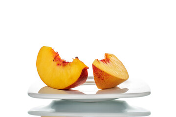 Naklejka na ściany i meble Two slices of sweet nectarine, close-up, isolated on white.