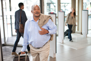 Fototapeta premium Senior man in airport with suitcase