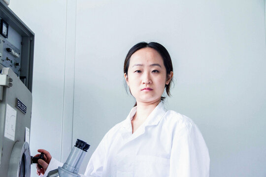Portrait of female scientist using lab equipment