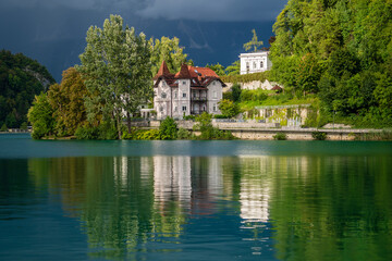 Bled lake and buildings in cloudy weather before rain and thunderstorms , Slovenia, Europe