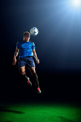 Male soccer player heading ball © Image Source Limited