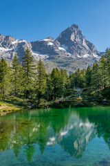 Fototapeta na wymiar Beautiful vertical view of Lago Blu or Layet lake, Aosta Valley, Italy, in which the Matterhorn is reflected