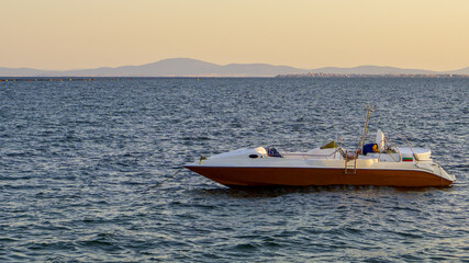 Naklejka premium Speed boat in to Black Sea. Sunset near Ravda, Bulgaria