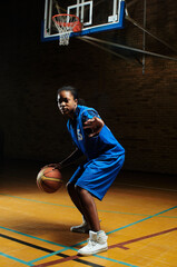 Naklejka premium Basketball player bouncing ball