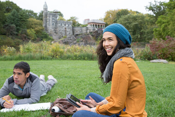 Fototapeta premium Students sitting in park doing homework