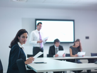 Portrait of businesswoman in meeting room with screen