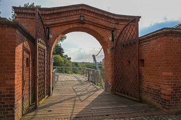 View to the draw bridge through the entrance gate of the historic brick fortress of Domitz on the river Elbe in northern Germany, copy space