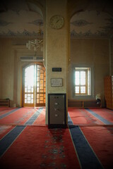 Front view of the money box in front of the wall, column inside the mosque.