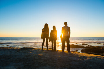 Three people at Windansea beach, La Jolla, California