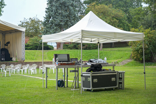 Tent for the sound engineers and their equipment at an open-air event on the lawn in the park