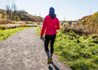 Young woman walking on track © Image Source Limited