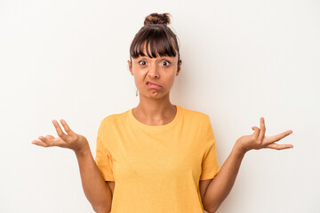 Young mixed race woman isolated on white background  doubting and shrugging shoulders in...