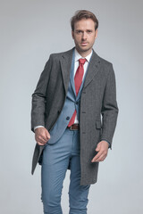 Fototapeta premium businessman holding his coat while posing with attitude