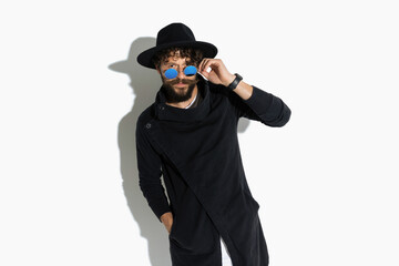 attractive casual man lowering his sunglasses