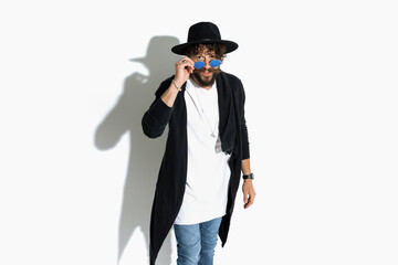 handsome guy looking over his sunglasses at the camera