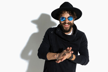 casual guy rubbing his palms and smiling at the camera