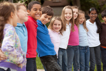Children standing in a row outdoors