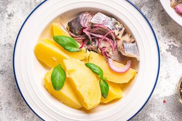 herring and potatoes second course marinated fish onion fresh ready to eat meal snack on the table copy space food background rustic