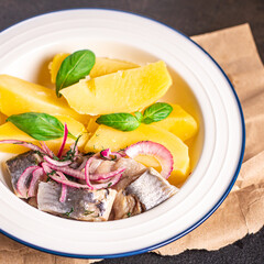 herring and potatoes second course marinated fish onion fresh ready to eat meal snack on the table copy space food background rustic