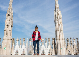 Woman standing on roof of Duomo Cathedral, Milan, Italy