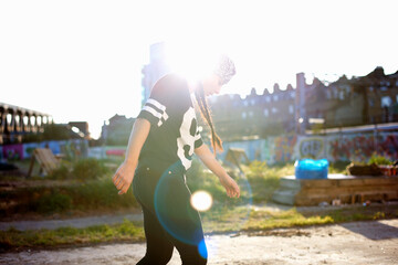 Young women dancing in the sunlight, backlit