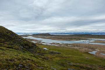 Fototapeta na wymiar Nunavut - a close up of a hillside next to a body of water