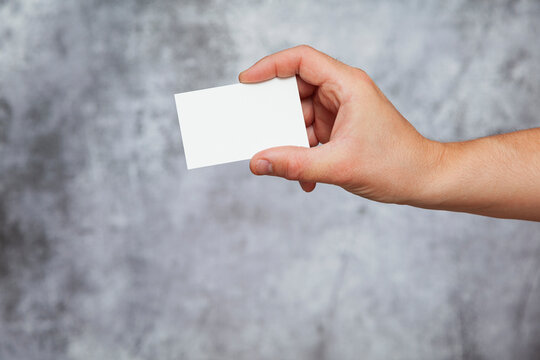 Human hand holding a blank card