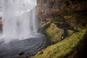 Male tourist at Seljalandsfoss waterfall, Iceland