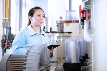 Young woman at work in flexible electronics plant - obrazy, fototapety, plakaty