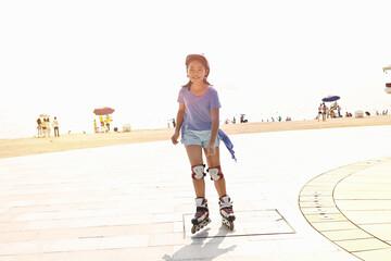 Girl rollerblading at beach, Zhuhai, Guangdong, China